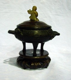 Appraisal: A Chinese tripod twin handled censer in bronze fitted with