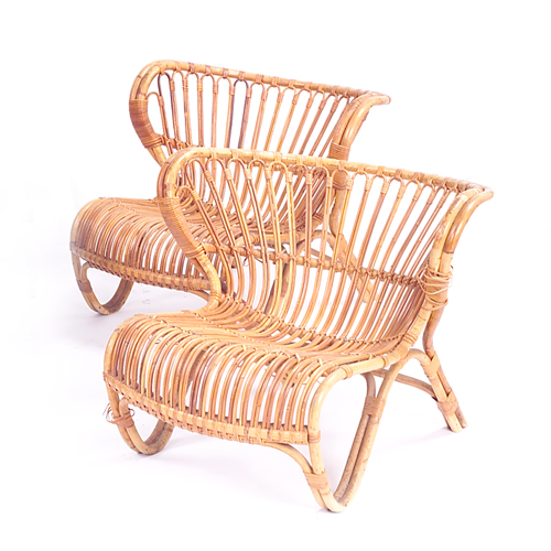 Appraisal: Pair of rattan lounge chairs on curvilinear frames