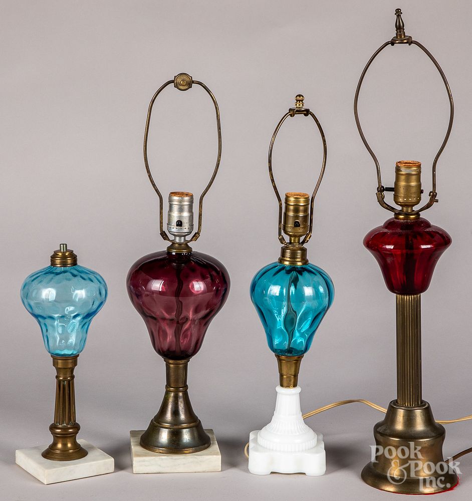 Appraisal: Four colored glass fluid lamps Four colored glass fluid lamps