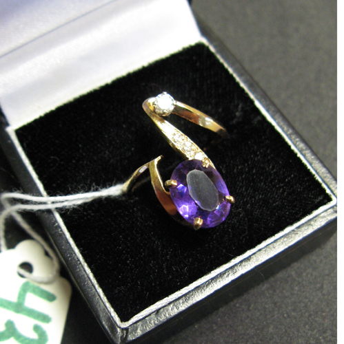 Appraisal: AMETHYST DIAMOND AND FOURTEEN KARAT GOLD RING set with an