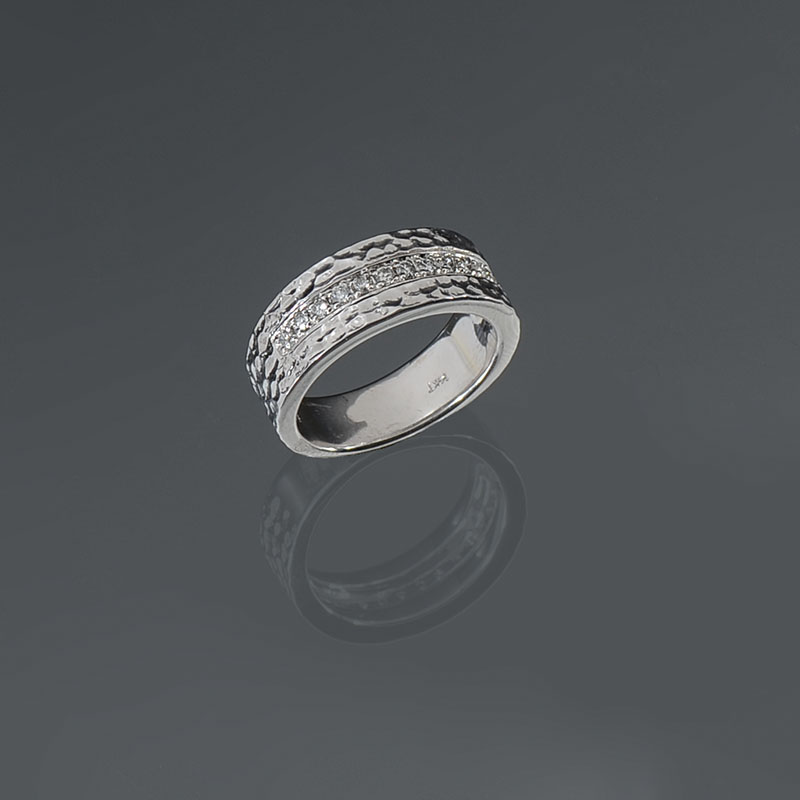 Appraisal: HAMMERED K BAND WITH CHANNEL SET DIAMONDS K hammered white