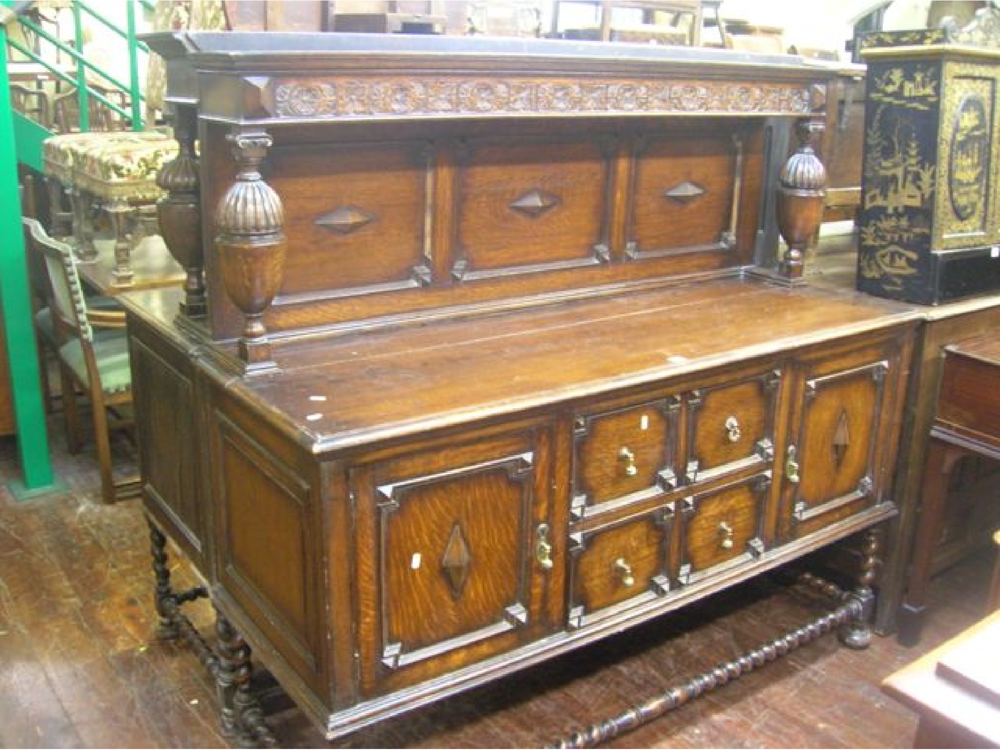 Appraisal: An Edwardian oak sideboard in the Jacobean manner the central