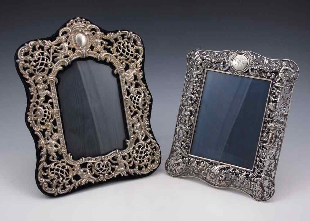 Appraisal: REPOUSSE PICTURE FRAMES To include Figural putti over black felt