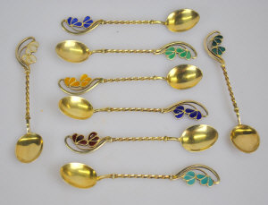 Appraisal: A set of eight continental gilt coffee spoons with enamelled