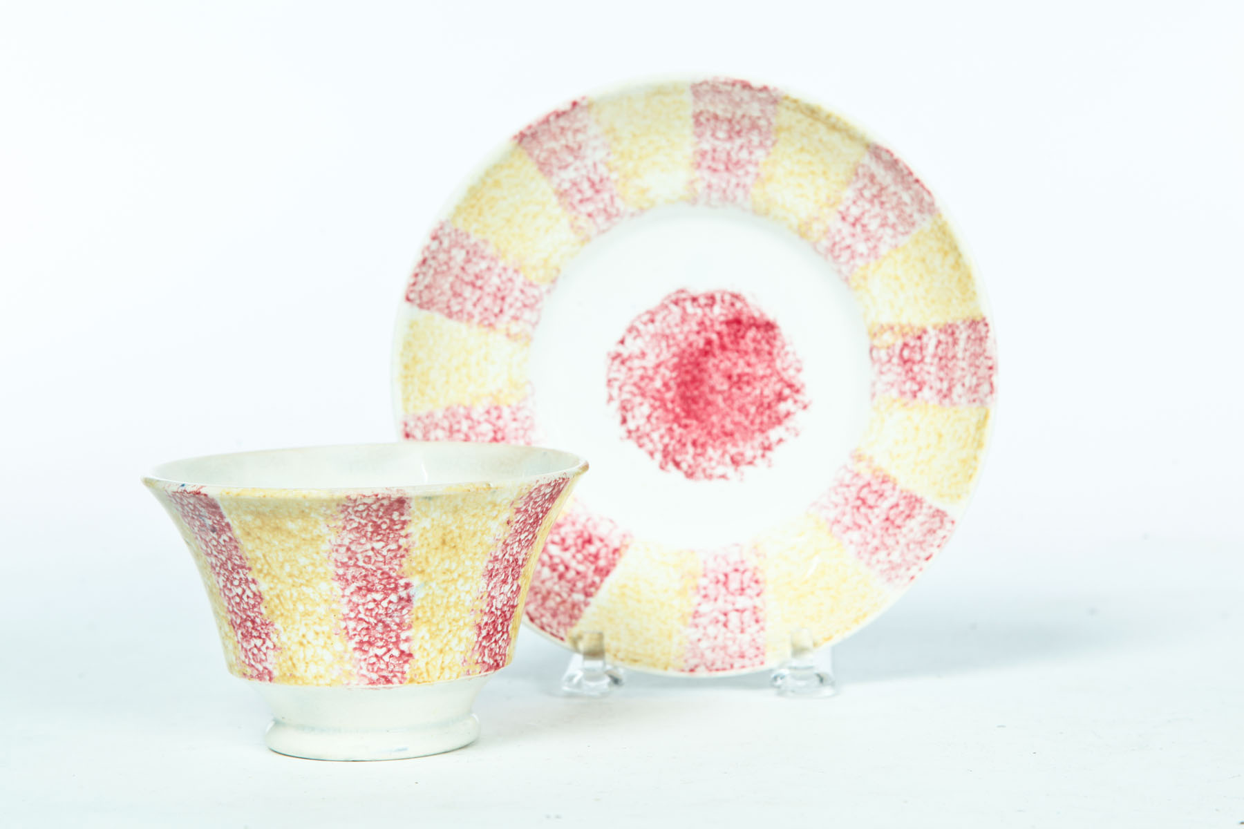 Appraisal: RAINBOW SPATTER HANDLELESS CUP AND SAUCER England nd quarter- th