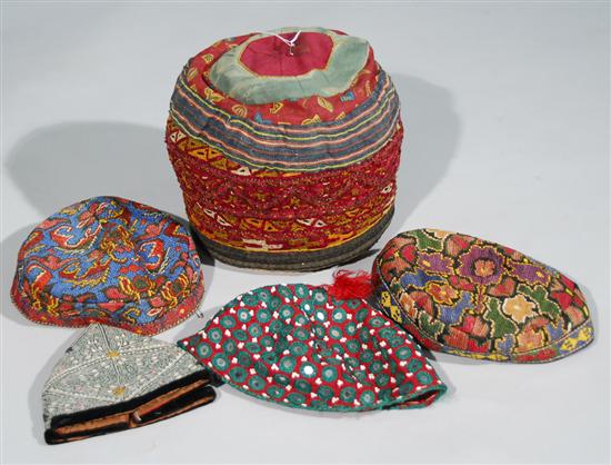 Appraisal: COLLECTION OF FIVE EMBROIDERED CAPS Afghani Uzbeki needlepoint and Pakistani