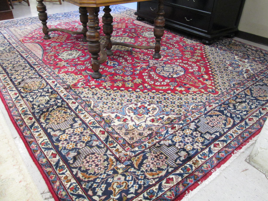 Appraisal: HAND KNOTTED PERSIAN CARPET overall floral design on red ground