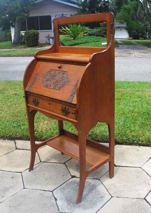 Appraisal: CARVED GOLDEN OAK SECRETARY DESK Top with mirror carved panel