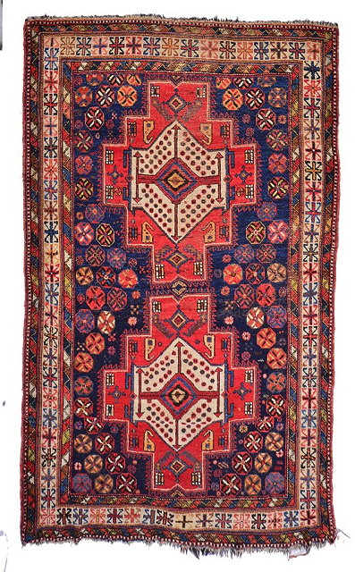 Appraisal: A PERSIAN AFSHAR BRICK RED GROUND RUG with two central