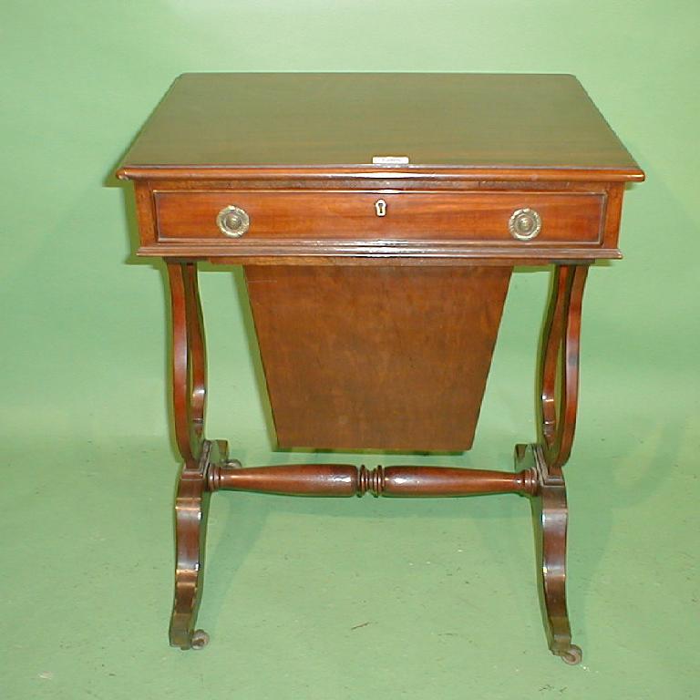 Appraisal: A Regency style mahogany work table with frieze drawer sliding