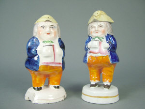 Appraisal: Two Toby salt and pepper shakers in coloured glazes on