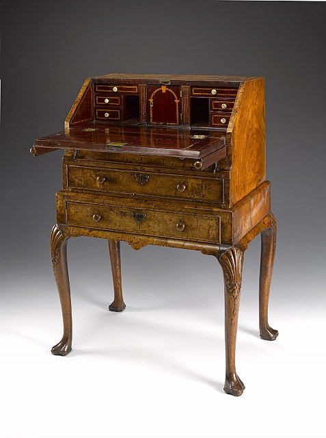 Appraisal: A GEORGE II FIGURED WALNUT BUREAU ON STAND the top