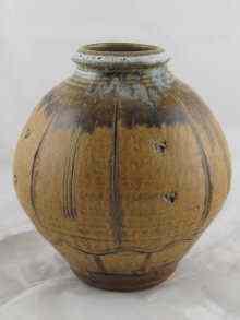 Appraisal: Mike Dodd British b A stoneware ribbed vase brown and