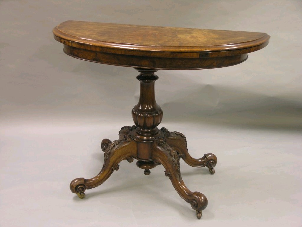 Appraisal: A Victorian walnut veneered card table demi-lune shape the revolving