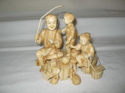 Appraisal: A CARVED IVORY OKIMONO of a fisherman and two boys