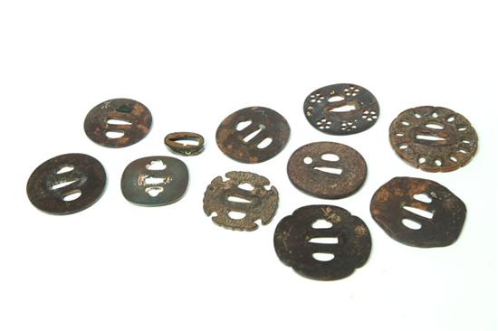 Appraisal: ELEVEN SWORD FITTINGS Japan probably th century Ten tsuba one