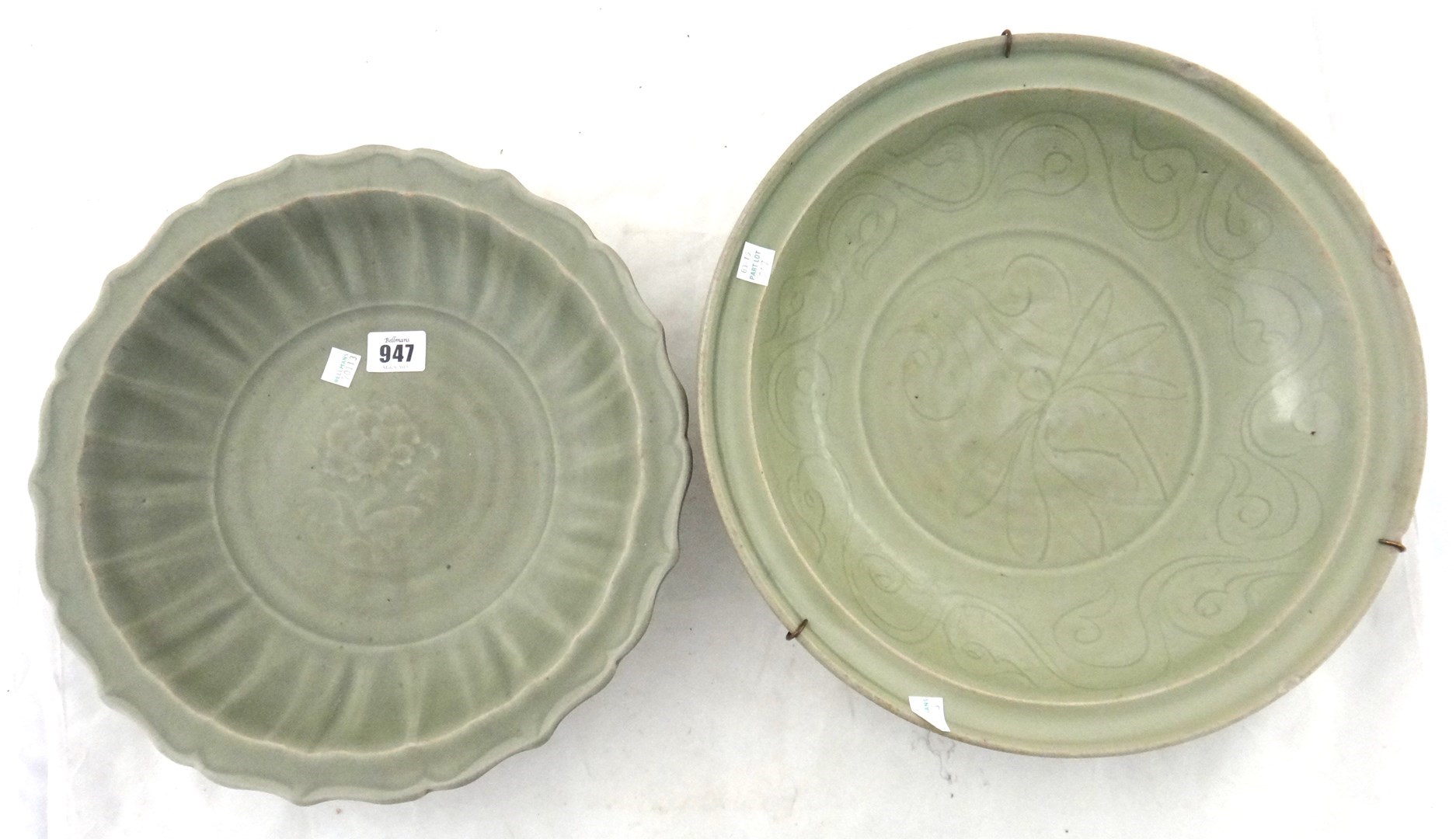 Appraisal: Two Chinese celadon dishes Ming Dynasty the larger carved with