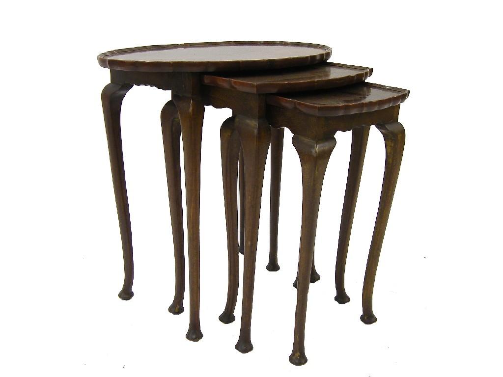 Appraisal: Mahogany nest of three oval tables each with cabriole legs