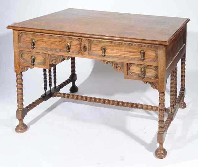 Appraisal: AN EARLY TH CENTURY OAK DESK with four drawers around