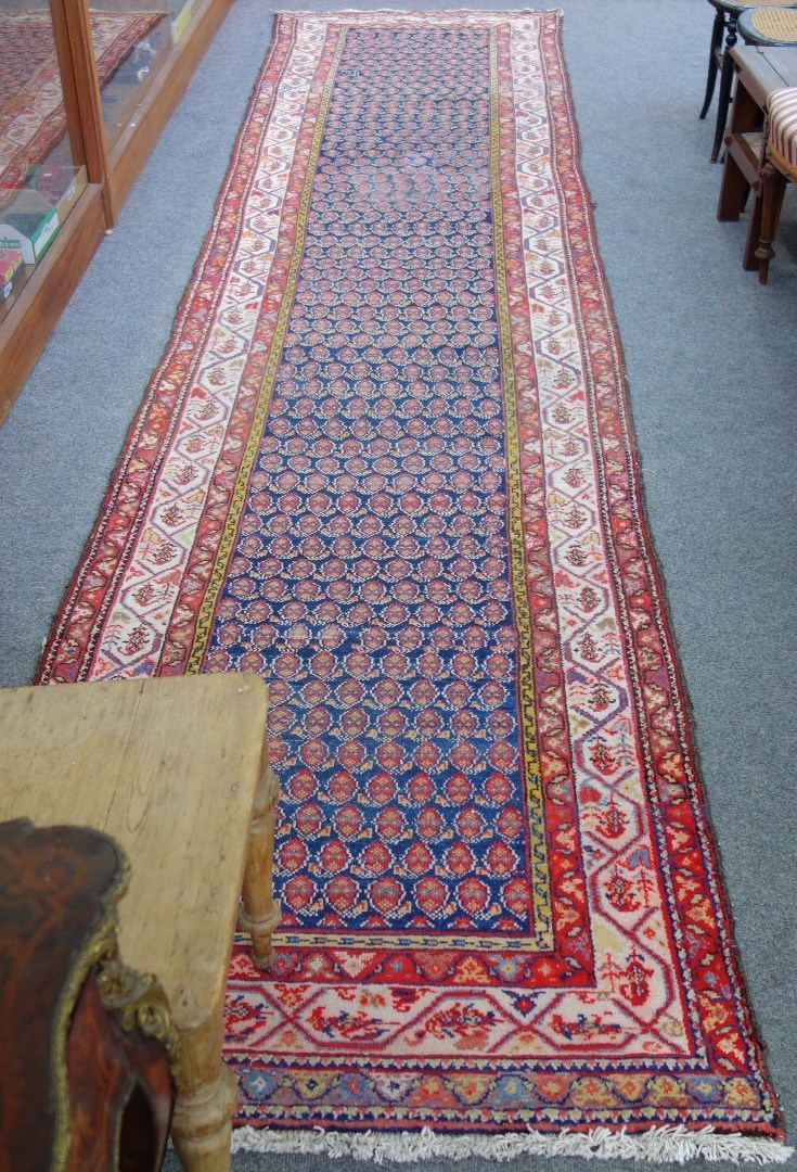 Appraisal: A North West Persian runner woven with multiple boteh on