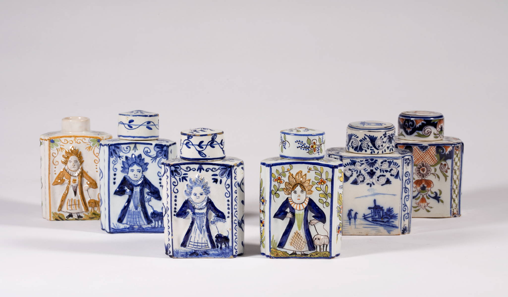 Appraisal: SIX DELFT TEA CADDIES WITH FIGURAL AND FLORAL MOTIFS SOME