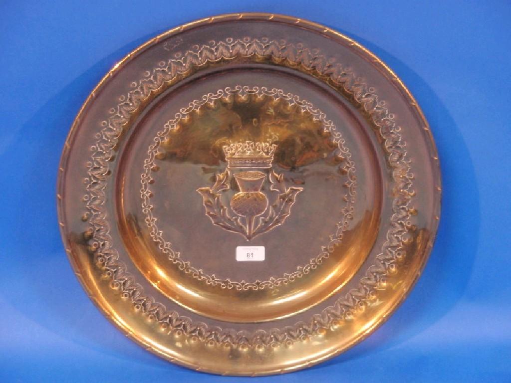 Appraisal: An embossed brass armorial charger with a thistle and crown