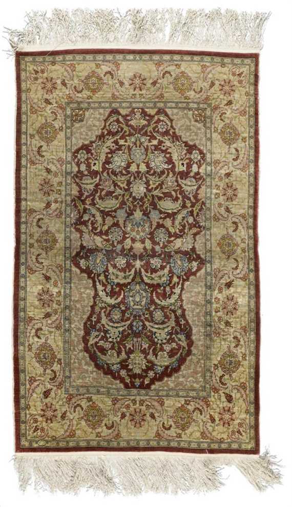 Appraisal: HEREKE silk old Red mihrab with light corner motifs the