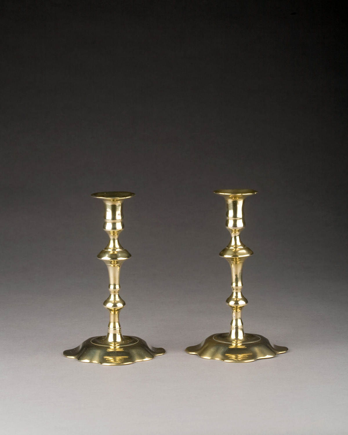 Appraisal: PAIR OF GEORGE III BRASS CANDLESTICKS CIRCA Each shaped nozzle