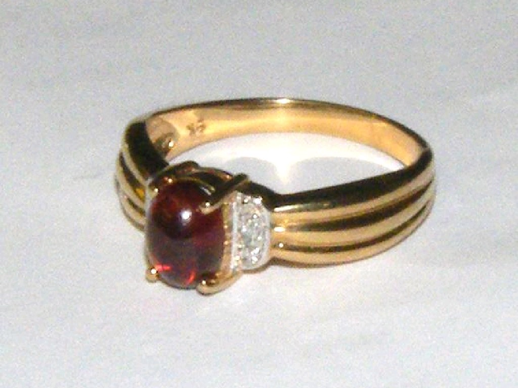 Appraisal: ct cabouchon garnet and diamond ring