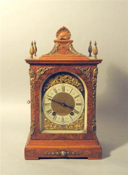 Appraisal: English gilt metal mounted walnut mantle clockThe top with a