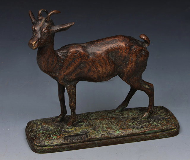 Appraisal: A BRONZE MODEL of a goat on a naturalistic base