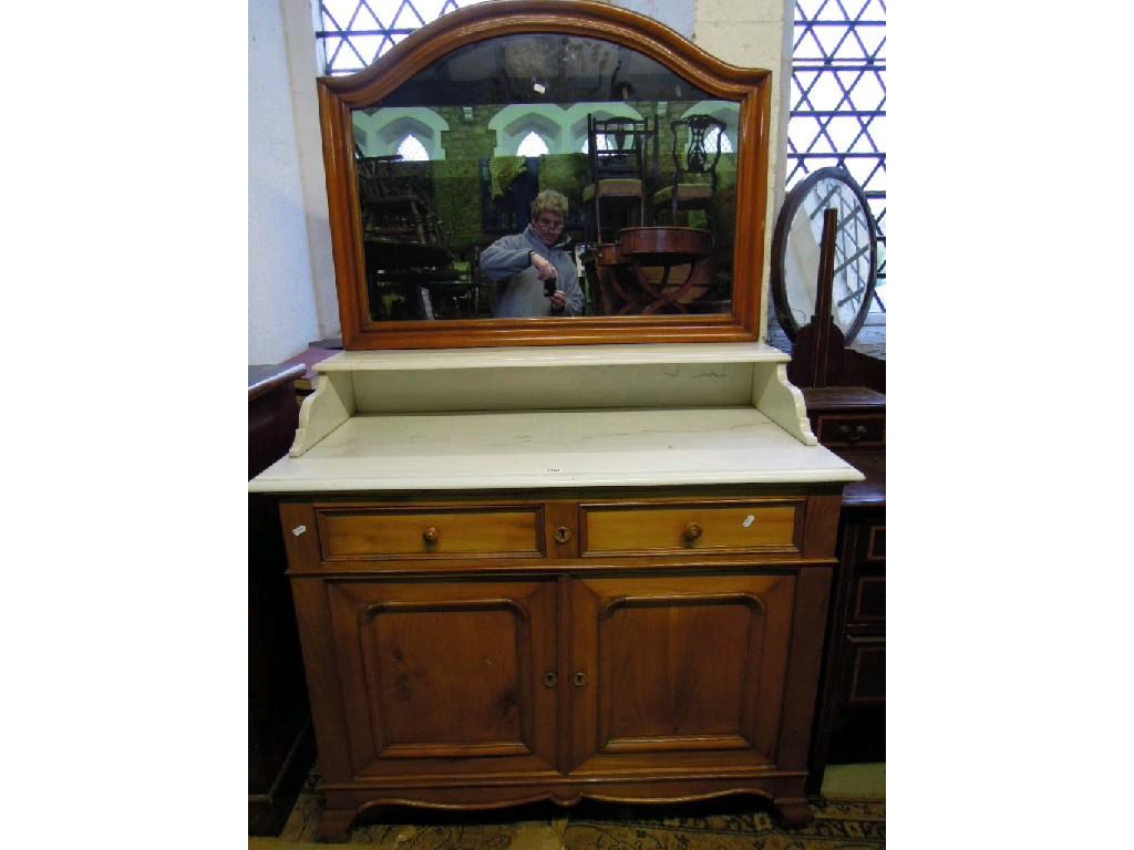 Appraisal: A continental fruitwood washstand with raised arched mirror back with