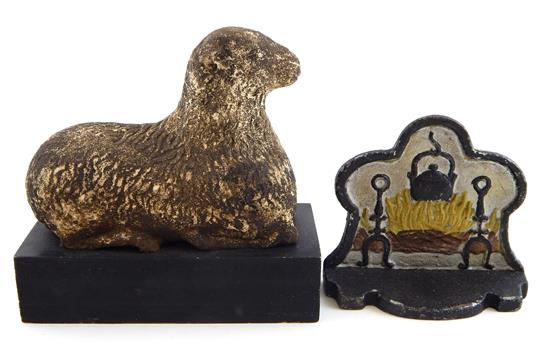 Appraisal: Two doorstops carved and painted stone reclining lamb on black