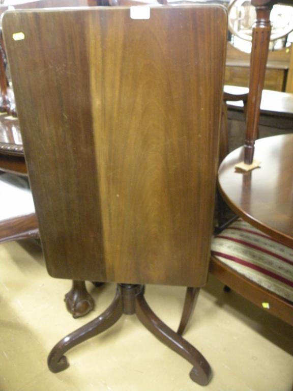 Appraisal: An early thC mahogany tilt top table the rectangular top