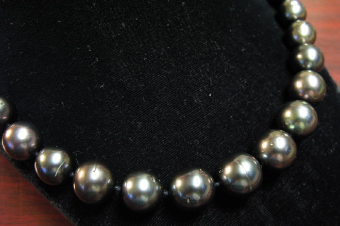 Appraisal: BLACK PEARL NECKLACE The inch princess length necklace is strung