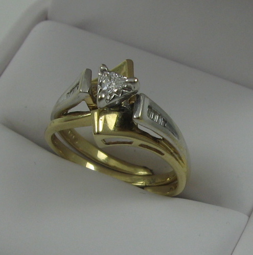 Appraisal: DIAMOND AND FOURTEEN KARAT GOLD RING with ring guard Set