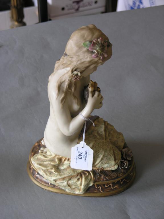 Appraisal: A Vienna style figure of a semi-nude girl kneeling and