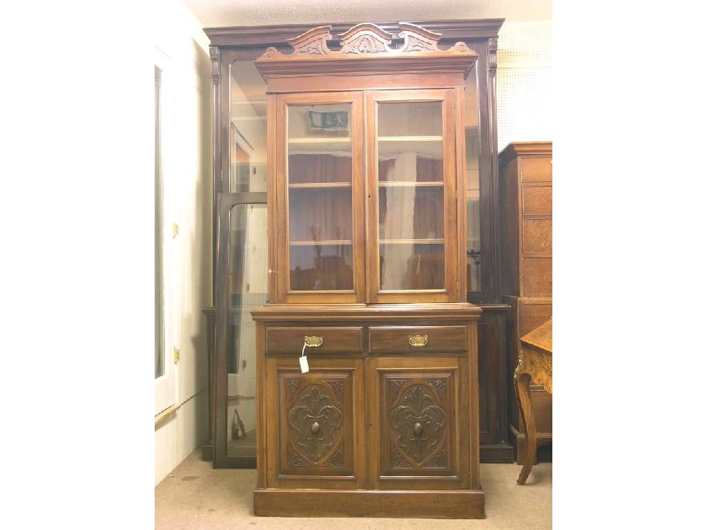 Appraisal: A Victorian walnut bookcase pair of glazed doors enclosing three