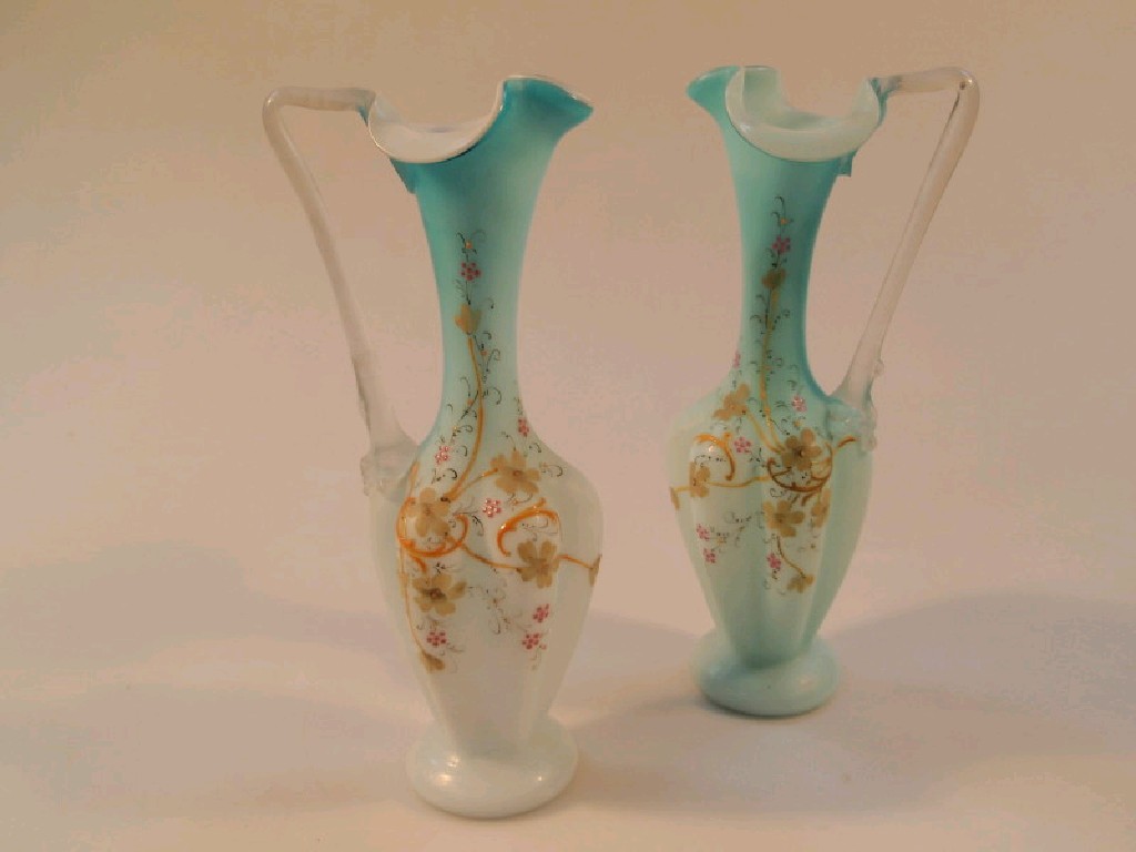 Appraisal: A pair of blue opaque satin glass ewers with fluted