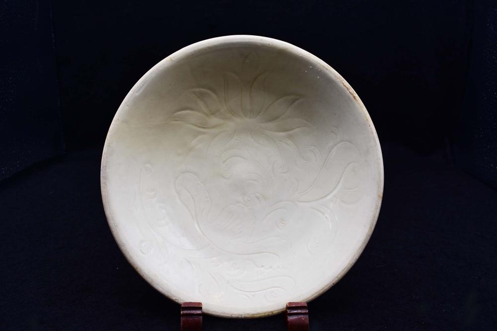 Appraisal: CHINESE CREAM GLAZED EARTHENWARE FOOTED PLATEProbably Song Dynasty Circular with