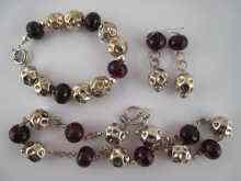 Appraisal: A suite of jewellery comprising a faceted garnet and white