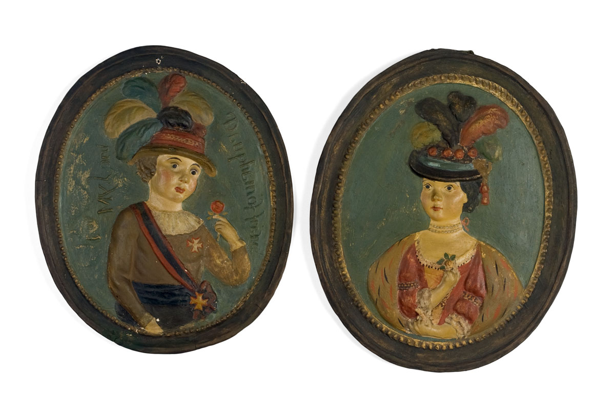 Appraisal: TWO MOLDED POLYCHROME-PAINTED PLASTER OVAL PORTRAIT PLAQUES NINETEENTH CENTURY The