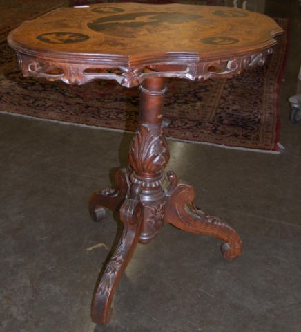 Appraisal: Black Forest style scenic inlaid occasional table with carved tripod