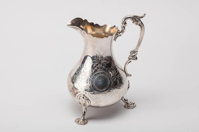 Appraisal: A VICTORIAN SILVER JUG with shaped rim scrolling acanthus leaf