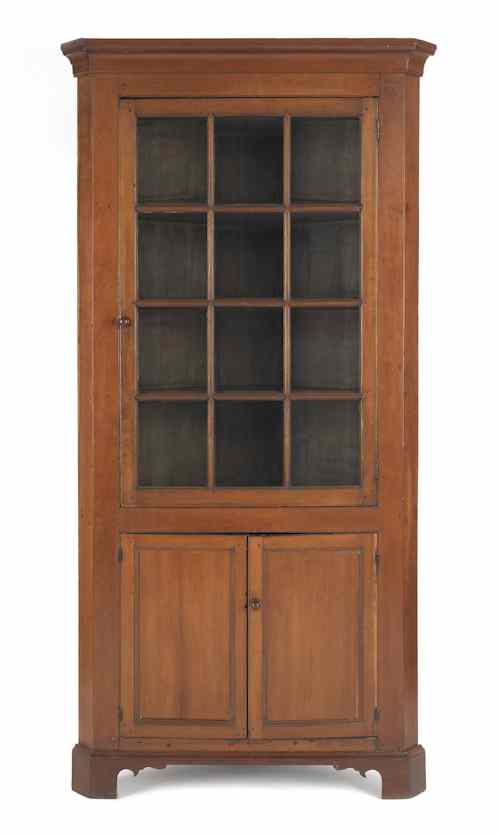 Appraisal: Pennsylvania cherry one-piece corner cupboard early th c h w