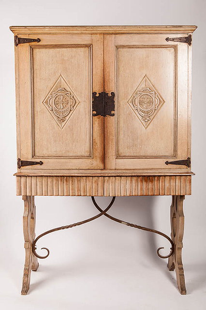 Appraisal: AN ARTS CRAFTS LIMED OAK CABINET ON STAND with iron