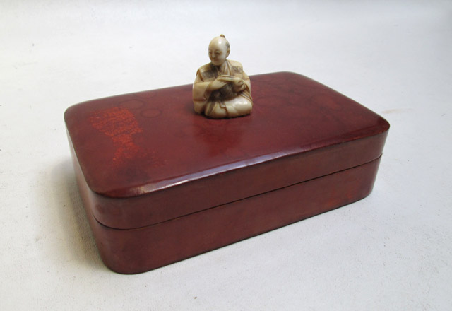 Appraisal: JAPANESE CARVED IVORY NETSUKE on Italian leather finished Marsh's hinge-top