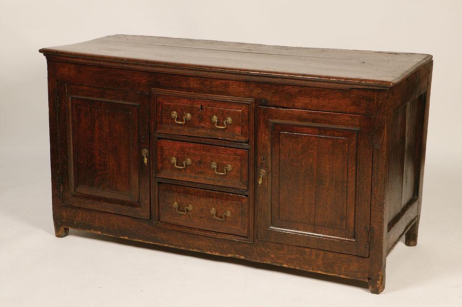 Appraisal: A GEORGE III OAK SIDEBOARD the rectangular top above a