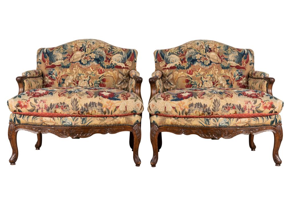 Appraisal: PAIR FRENCH PROVINCIAL CARVED WALNUT BERGERESeach covered with floral tapestry