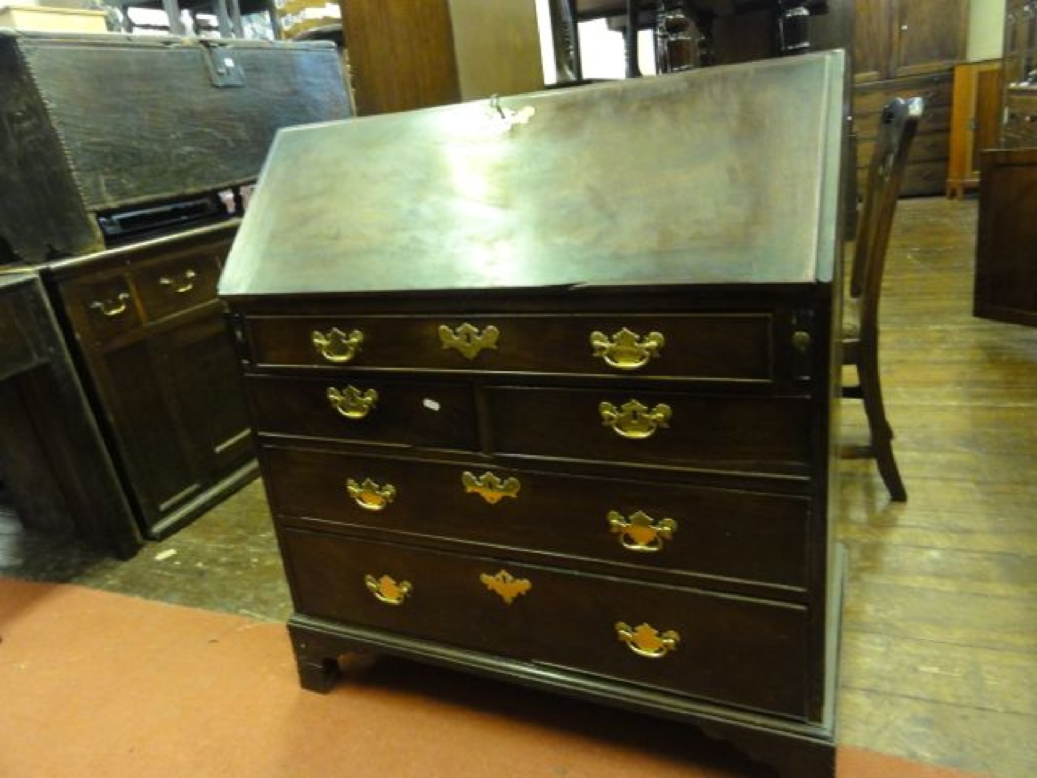 Appraisal: A George III mahogany bureau fitted with three long and